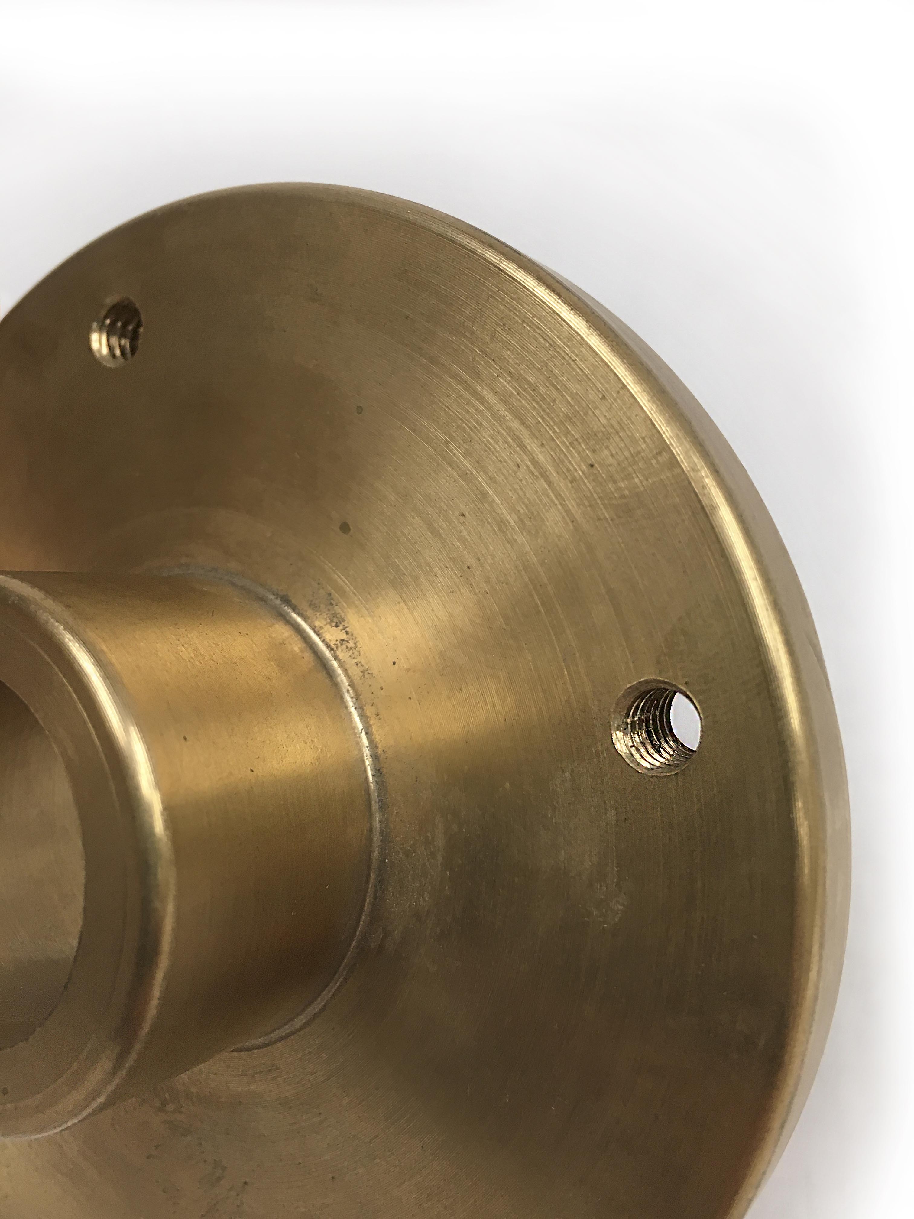 Machined Part - Bronze bushing: (4) ¼ in.-20 tapped holes equally spaced on a 3 ¼ in. B.C.
